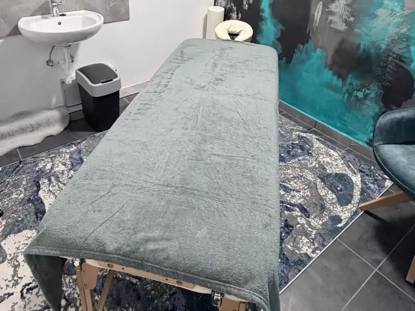 Massage room at the Movement Club: treatment couch against the painted wall